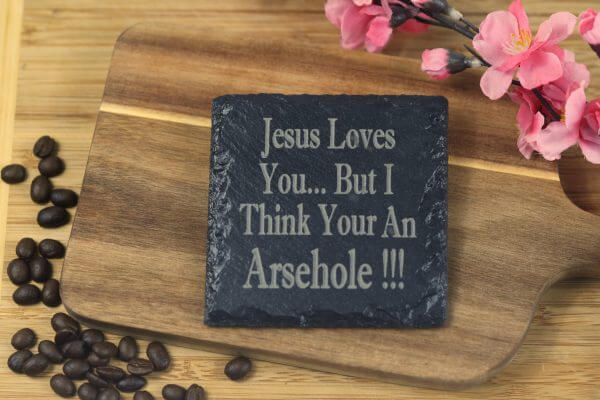 Jesus loves you but I think your an a***hole Slate Coaster