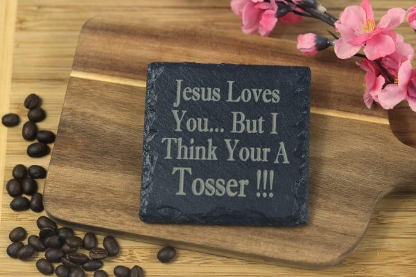 Jesus loves you but I think your a t***er Slate Coaster